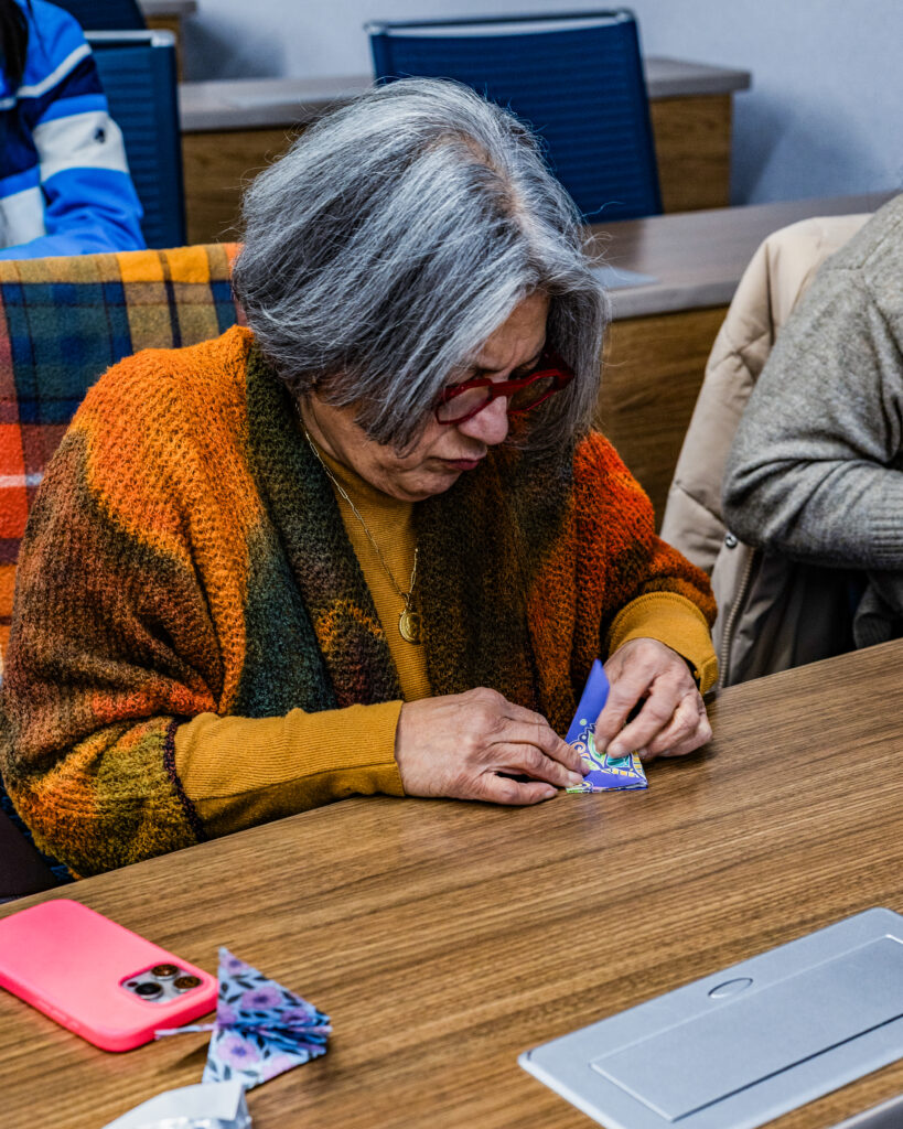 woman folds an origami bird
