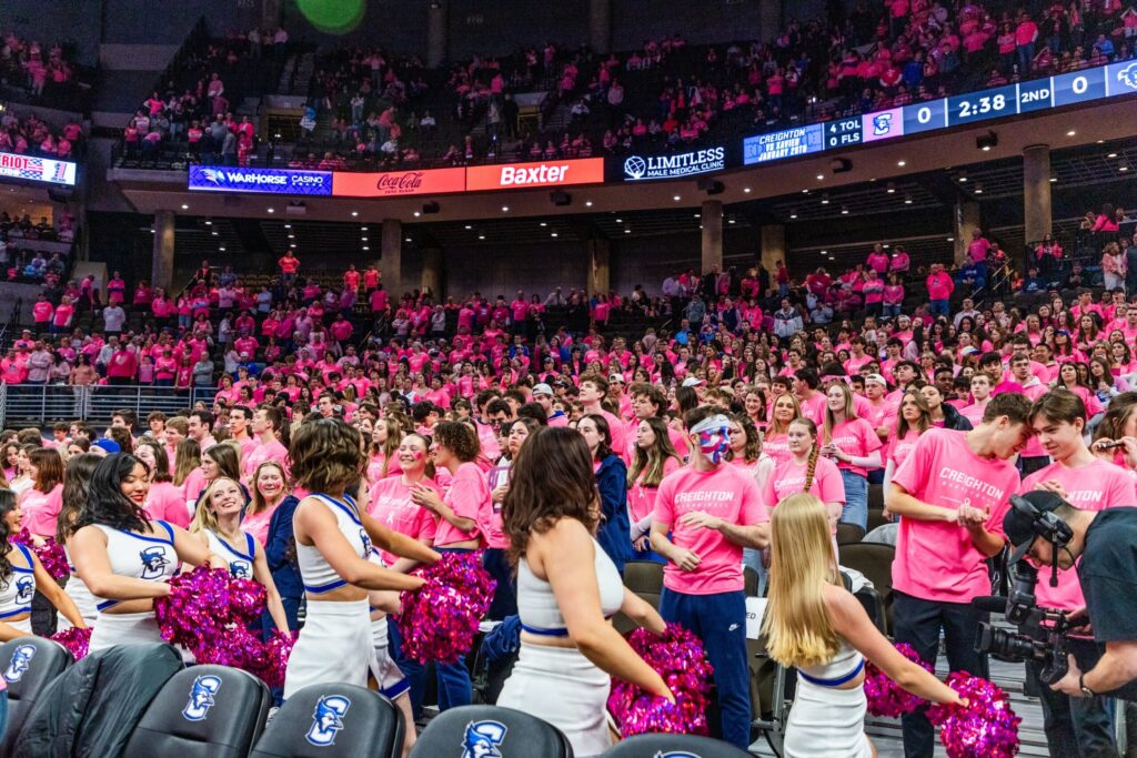 A sea of basketball fans cheer during a game.