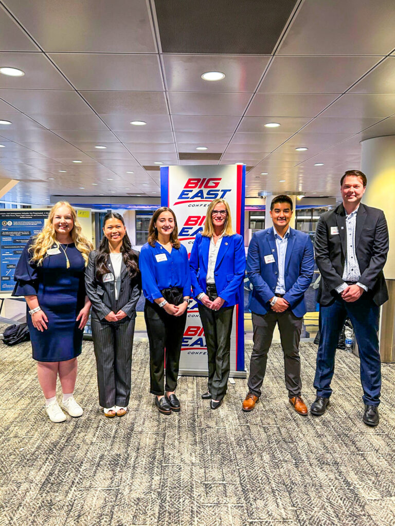 Six people pose together at the Big East Research Symposium