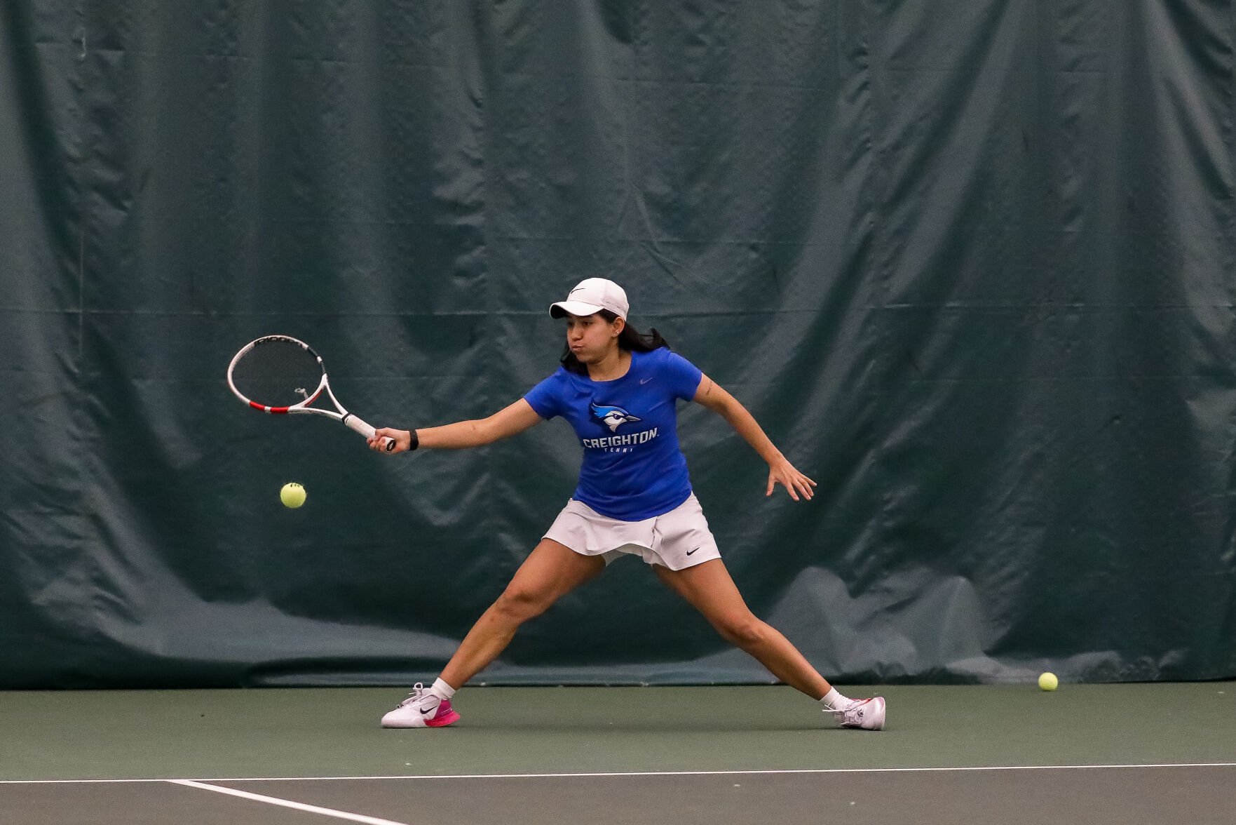 Junior Ana Paula Martinez lunges and sets up for a forehand in the Bluejays' match against the University of Idaho.