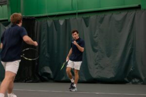 Senior Ethan Neil pumps his fist after winning a crucial point against Nebraska-Kearney to help lead Creighton to its fifth-straight victory of the early season.