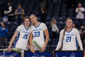 Seniors Lauren Jensen, Brooke Littrell and Molly Mogensen stand together during the Senior Day ceremony following the team's victory over Georgetown.