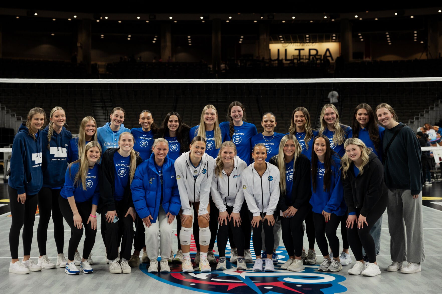 The Creighton volleyball team stands with the Bluejays' graduated seniors who are playing professionally.