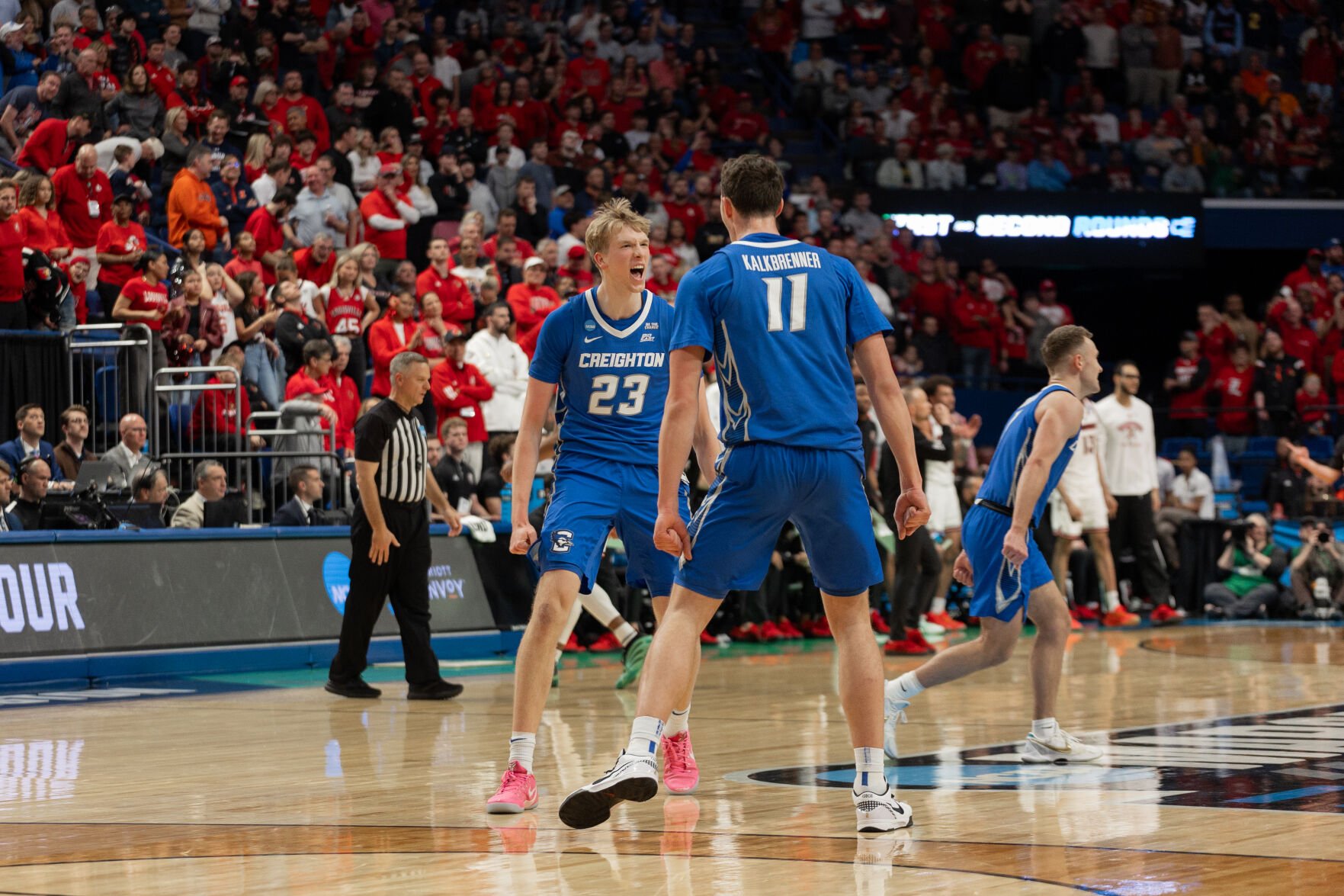 Freshman Jackson McAndrew and senior Ryan Kalkbrenner celebrate the team's performance against Louisville in the Round of 64.