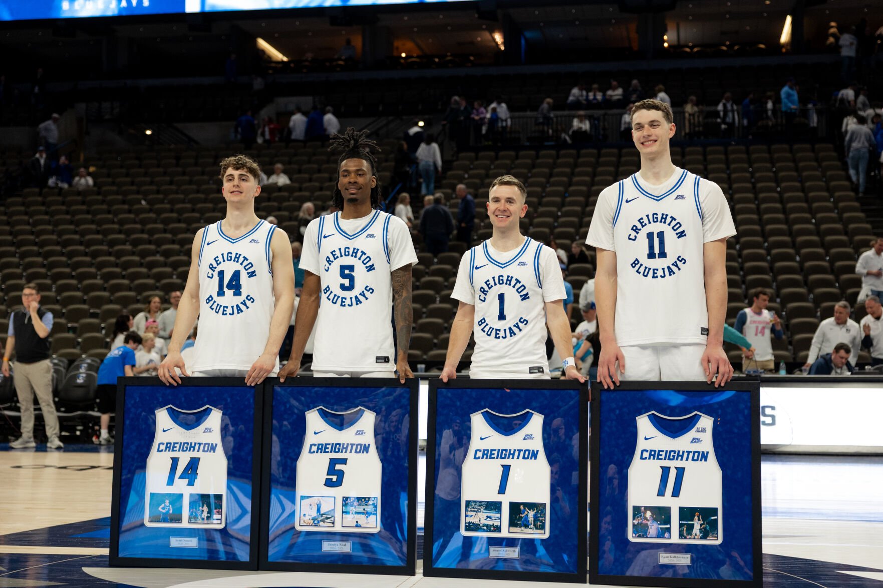 Creighton's four graduating seniors, Sami Osmani, Jamiya Neal, Steven Ashworth and Ryan Kalkbrenner stand together during the Senior Day celebration with framed jerseys standing up in front of them.