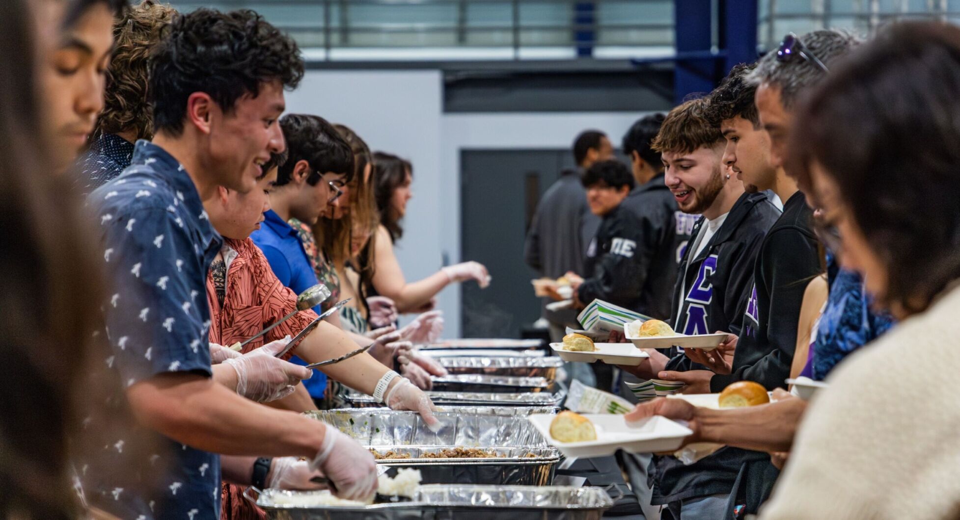 Students and parents alike flock to the Kiewit Fitness Center to enjoy li hing pineapple and other Hawaiian treats at the annual Lū'au event.
