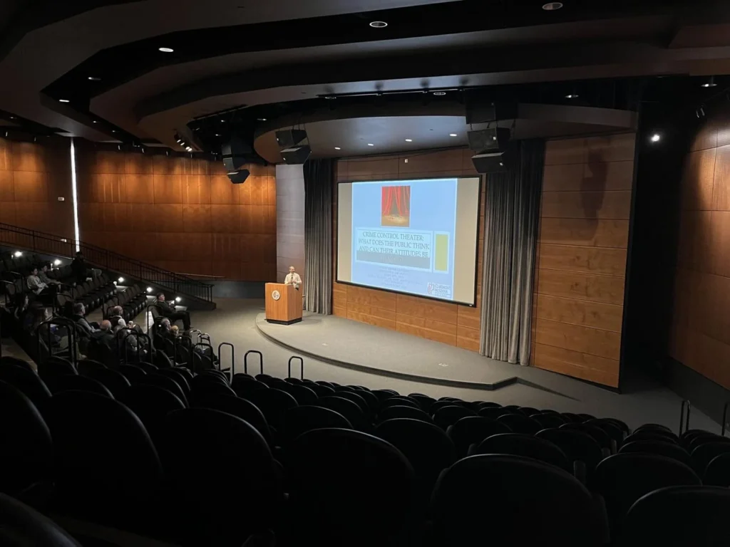 Professor speaks to an auditorium