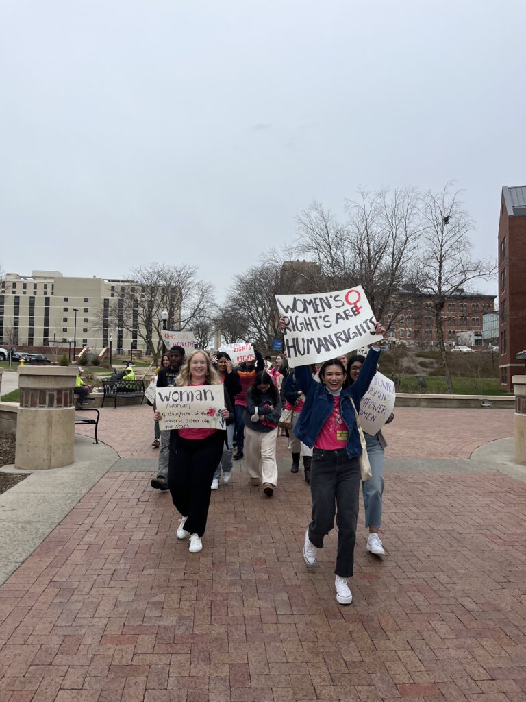 Women march outside down the California Street Mall