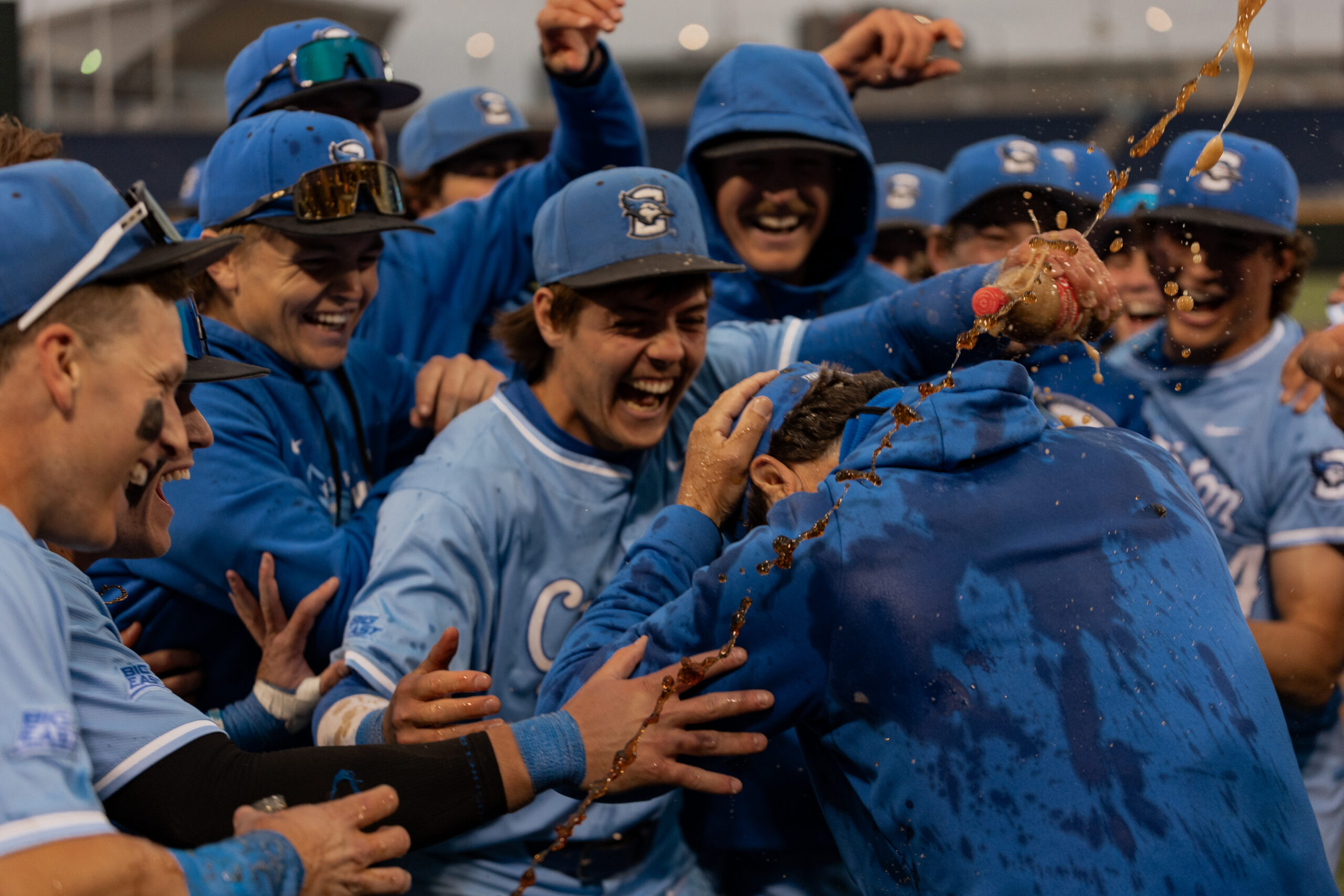Graduate student Kyle Hess and the rest of the team pour Coke on Head Coach Ed Servais to celebrate his 700th career win.