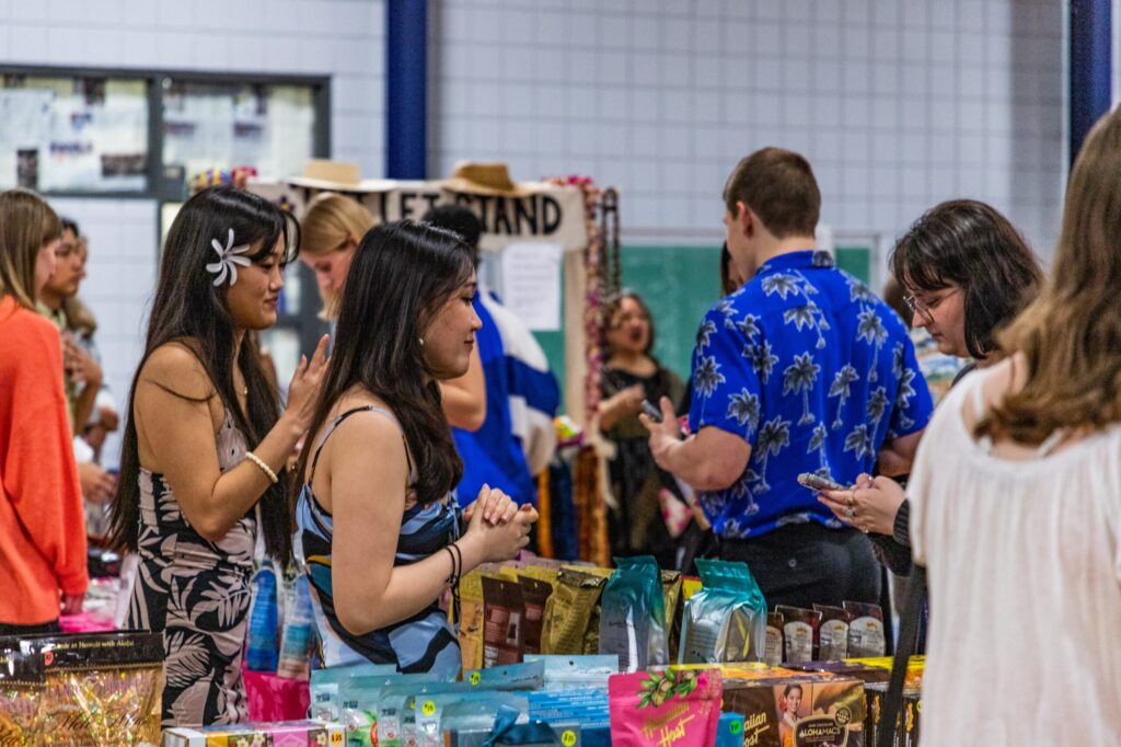 People shop at tables set up as a country store