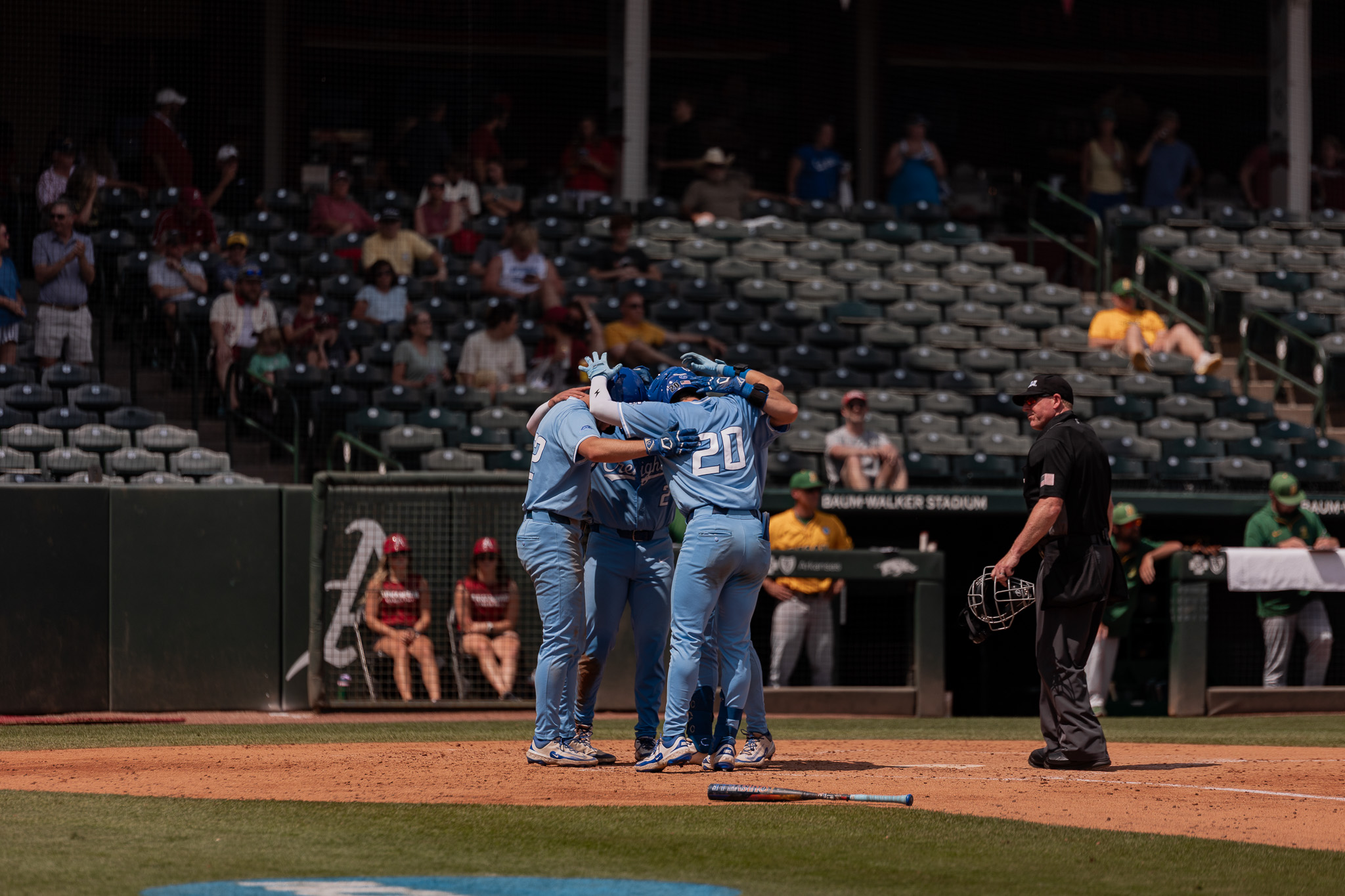 The Jays come together at home plate after a three-run homer from graduate student Kyle Hess.